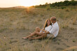 © STUDIO TAURUS/Stocksy - Careless young couple sitting at the beach and hugging