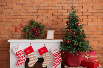 Canvas Print - Fireplace with Christmas wreath, fir tree and presents near brick wall