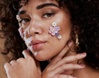 © J Maas/peopleimages.com - Beauty, flowers and makeup, portrait of black woman from Brazil with beautiful face on studio background. Nature, luxury makeup and art, natural flower skincare product for facial on fashion model.