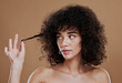 © J Maas/peopleimages.com - Hair care, beauty and black woman with an afro in studio with clean, short and curly hair style. Health, hairstyle and African model with natural hair for cosmetic salon treatment by brown background