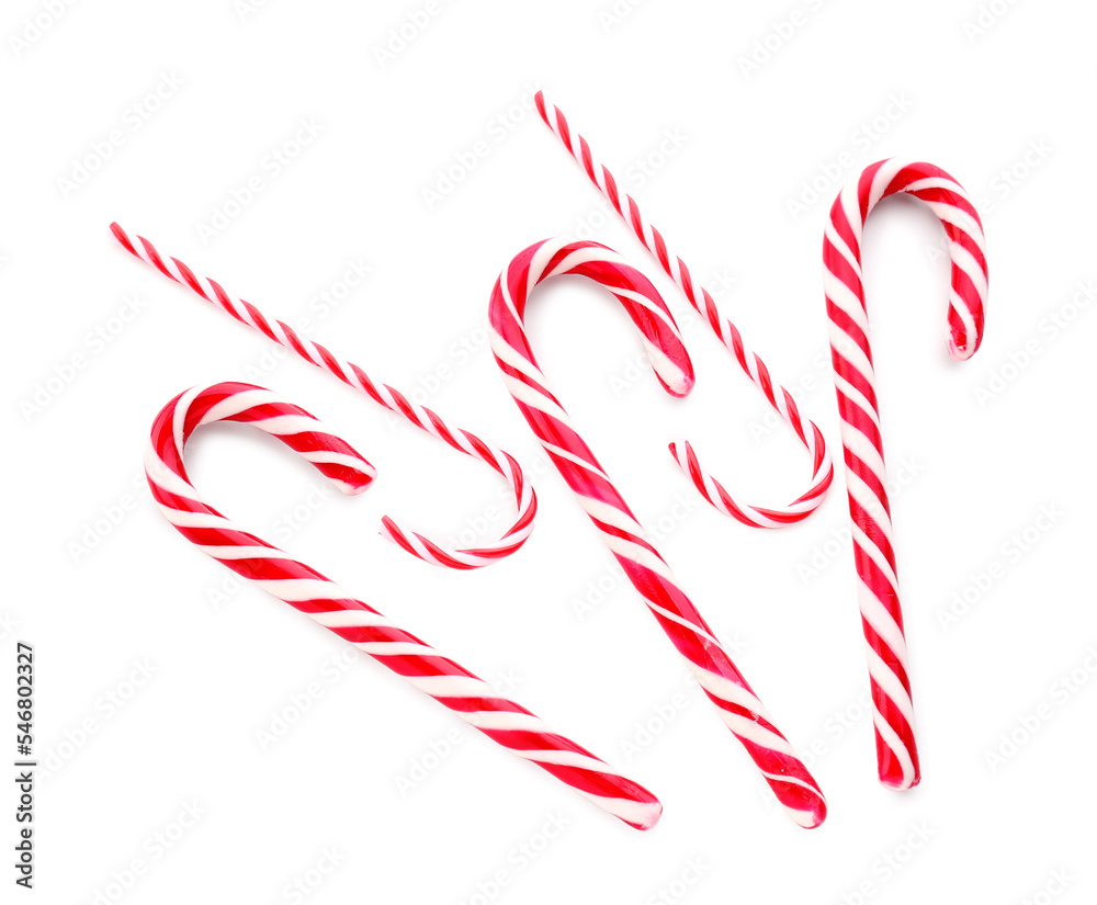 Composition with tasty candy canes on white background