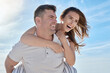 © Jade M/peopleimages.com - Love, beach and piggy back couple smile with blue sky on romantic summer holiday at ocean. Romance, man and woman have fun at sea for honeymoon, vacation time for happy couple together in Australia.
