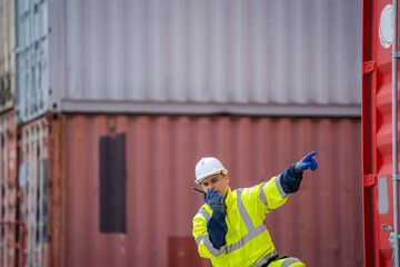 Poster - Foreman checking about shipping of container box in warehouse stock yard.