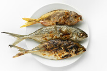 Top Down View Or Flatlay Closeup Served Grilled Burn Three Fish In A White Round Plate On Isolated Clean White Background. Food Rich In Omega-3 Fatty Acids