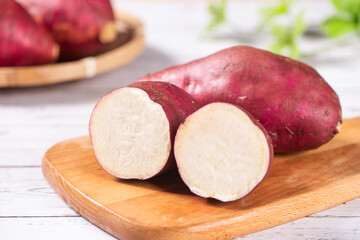 Raw fresh cut sweet potato on rustic wooden table