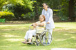 © GAJENDRRA BHATI  - Indian caregiver nurse taking care of senior female patient in a wheelchair outdoor at park, Asian doctor help and support elderly mature older people. rehabilitation and health care.