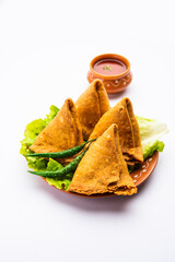 Wall Mural - samosa or singara. Indian fried or baked pastry with a savory filling, spiced potatoes, onion, peas