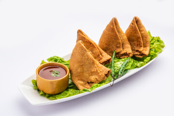 Wall Mural - samosa or singara. Indian fried or baked pastry with a savory filling, spiced potatoes, onion, peas