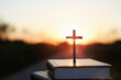 Bright sun light and bible book and the cross silhouette of the Holy Jesus Christ guiding the bright path
