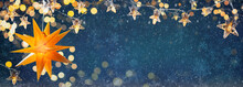 Yellow Shining Star And Christmas Garlands On A Blue Abstract Background With Bokeh And Snowflakes