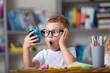 © BillionPhotos.com - School boy dreaming with alarm clock in classroom