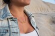 Closeup of a Hispanic woman wearing a gold name necklace.