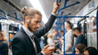 © yurolaitsalbert - business man reading an SMS while standing in the subway car .