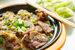 angle view clay pot rice with pickled duck and chopped pork and vegetable