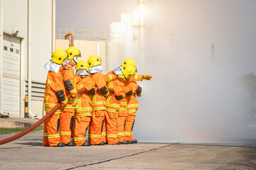 Firefighter training,Instructor Training on the use of fire hoses extinguisher for fighting fire in the factory