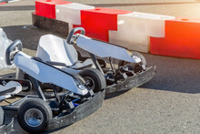Karting Mini Cars In The Parking Lot Near The Track Red-white Fences.