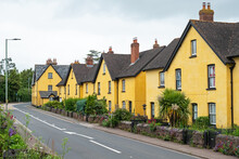 Uniformly Painted Houses Lining A Village Roadside In East Devon, UK