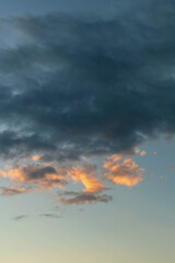 Wall Mural - dark rain clouds backlit by the evening sun as a natural background