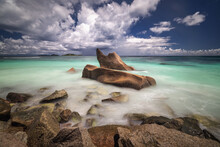 Granite Rocks In The Sea On A Tropical Beach In Seychelles