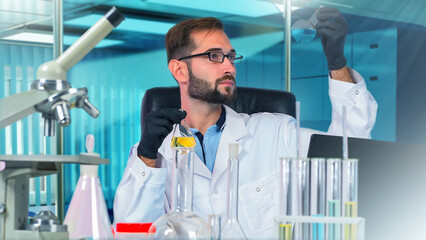 Poster - laboratory assistant. man is chemist. guy at table with test tubes. male laboratory assistant examin