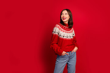 Canvas Print - Portrait of attractive cheerful girl put arms pockets toothy smile look empty space isolated on red color background