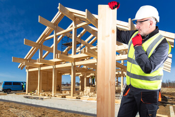 Poster - Construction company worker. Man in construction uniform thought. Man builder scratches chin. Guy holds beam for building house. Foreman stands at construction site. Construction country cottage