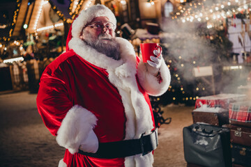 Poster - Photo of retired positive man hold mug delicious tasty beverage eggnog hot chocolate tea enjoy spending time midnight snowy street outside