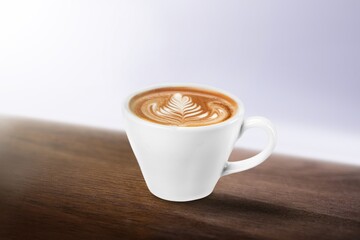 Wall Mural - Cup of tasty sweet hot coffee on desk