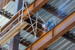 © rodrigo - rusted steel structure while a man is welding joints, mexico guadalajara
