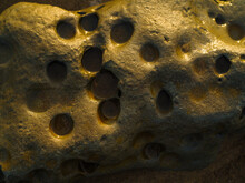 Macro Shot. Stone Sandstone With Round Holes From Corrosion, Atmospheric Phenomena. Abstraction, Minimalism. Nature, Ecology, Geology. There Are No People In The Photo.