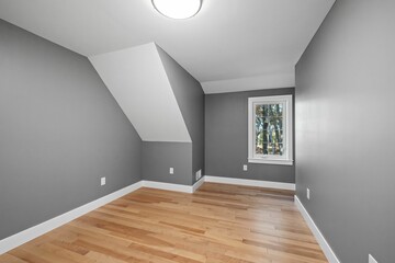 Poster - Empty luminous interior of an elegant modern colonial house with slick gray walls and a large window