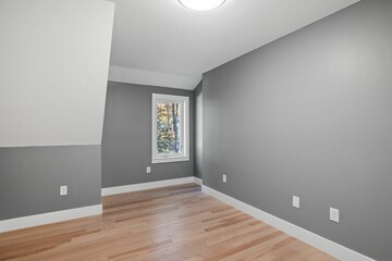 Poster - Empty luminous interior of an elegant modern colonial house with slick gray walls and a large window