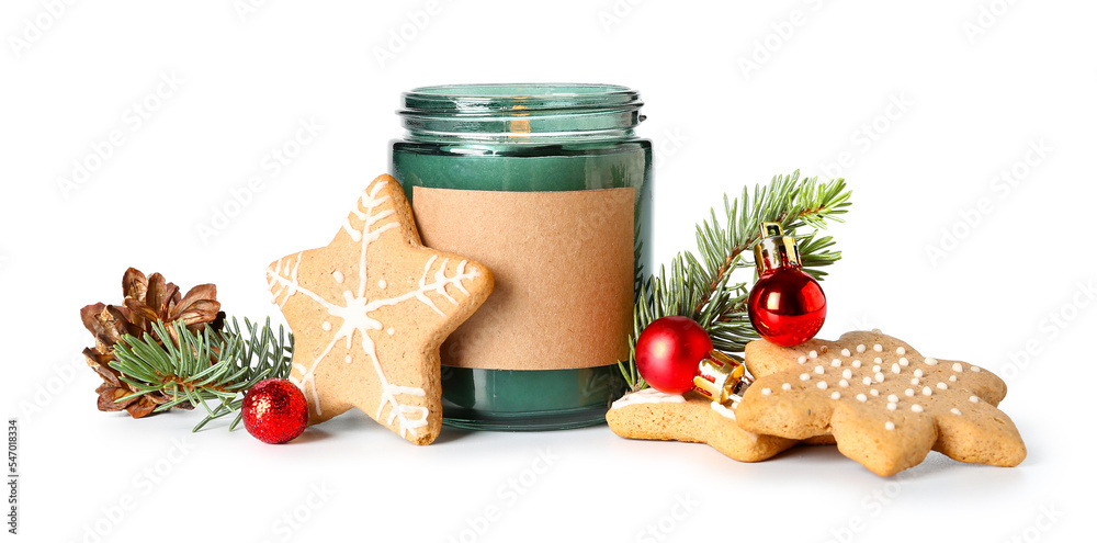 Burning candle with Christmas balls, fir branches, cone and cookies on white background