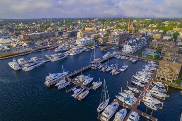 Aerial shot of the Newport Harbor in Rhode Island with ducked boats and a landscape