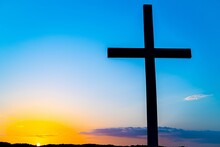 Silhouette Of A Christian Cross Against A Beautiful Sunrise Sky