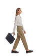 © New Africa - Young woman in casual outfit with black bag walking on white background