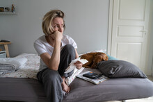 Depressed Middle-aged Woman Looks Away To Get Distracted From Financial Crisis And Life Problems. Unkempt Mature Female Props Chin With Hand Holding Unpaid Bills On Bed Regretting About Past Closeup