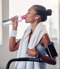 Canvas Print - Drinking water, fitness and smartphone on woman arm gym gear, technology and listening to music for workout on stationary cycling machine. Tired, challenge and motivation black woman cardio training