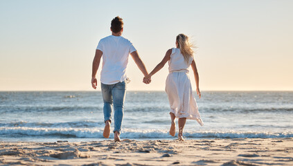 Wall Mural - Couple, hand holding and vacation at beach, love and trust together with travel and adventure with nature and ocean view. Man, woman bonding and back view, support with sea, sand and romantic holiday