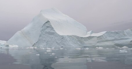 Wall Mural - global warming aerial video. greenland iceberg landscape with giant icebergs from melting glacier. a