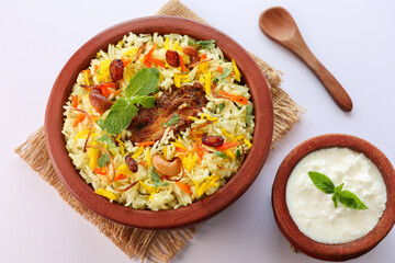 Wall Mural - Chicken biryani Spicy Indian Malabar biryani Hyderabadi biryani, Dum Biriyani pulao golden bowl Kerala India Sri Lanka Pakistan basmati rice mixed rice dish with meat curry Ramadan Kareem, Eid