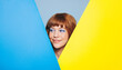 © Jacob Lund - Happy woman with ginger hair and blue eye shadow standing behind colour placards