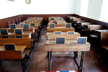 Old Historical Classroom With Wooden Desks And Chalkboards