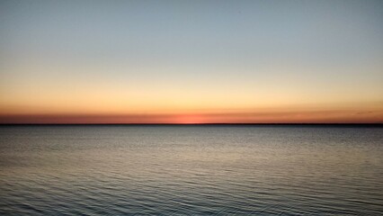  Warm orange sunset horizon on the ocean.