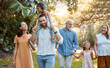 © L Ismail/peopleimages.com - Big family, garden and bonding with children, grandparents and siblings during summer on holiday. Grandfather, grandmother and parents walking through forest for loving, caring fun with kids