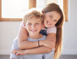 Family, hug and portrait of girl an boy in a living room, bonding and happy while enjoying quality time together. Face, happy family and sibling brother and sister embrace, playful and relax at home