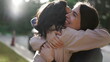 © Marco - Two happy female best friends hugging each other. Women embrace reunion outdoors at park2