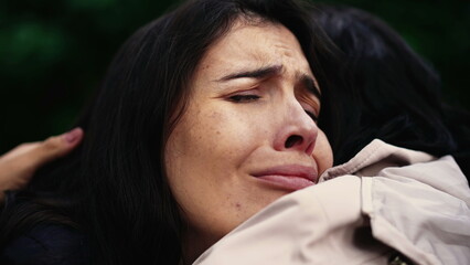 Wall Mural - Sorrowful woman closeup face with negative emotion hugging friend