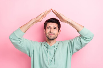 Sticker - Portrait of minded person look interested arms make roof gesture above head isolated on pink color background