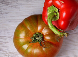 Wall Mural - red bell pepper and tomato on wooden table